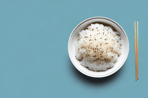A bowl of steaming rice with a lid on top
