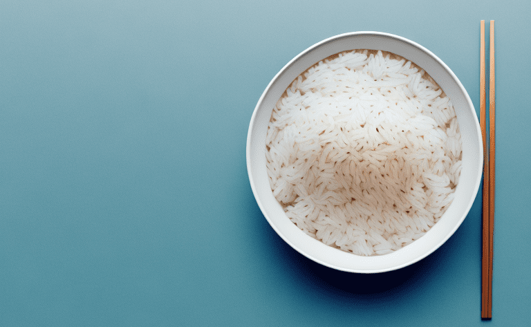 A bowl of cooked rice with a spoon sitting beside it