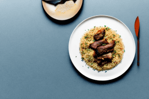 A plate of moroccan lamb and date couscous