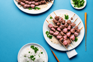 A plate of greek lamb souvlaki skewers with tzatziki and rice