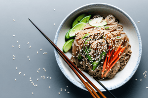 A bowl of cold soba noodle salad with ponzu dressing