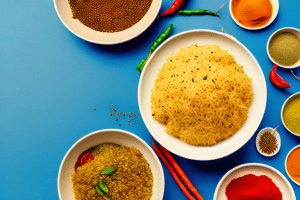A bowl of steaming indian-style rice with colorful spices and vegetables