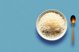 A bowl of riz soufflé with a spoon and a few grains of rice scattered around it