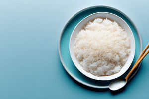 A bowl of steaming white rice with a spoon