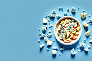 A bowl of apple slices topped with blue cheese crumbles